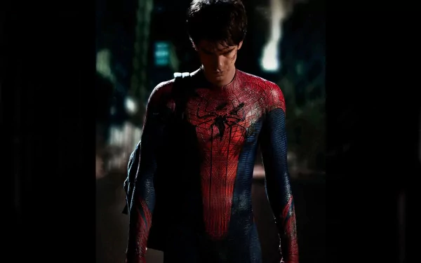 A dramatic HD wallpaper from The Amazing Spider-Man, featuring the superhero in his iconic suit, standing in a moody urban environment.