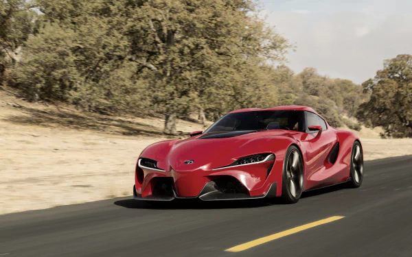 Red Toyota FT-1 supercar driving on a scenic road, captured in HD for a vibrant PC desktop wallpaper and background.