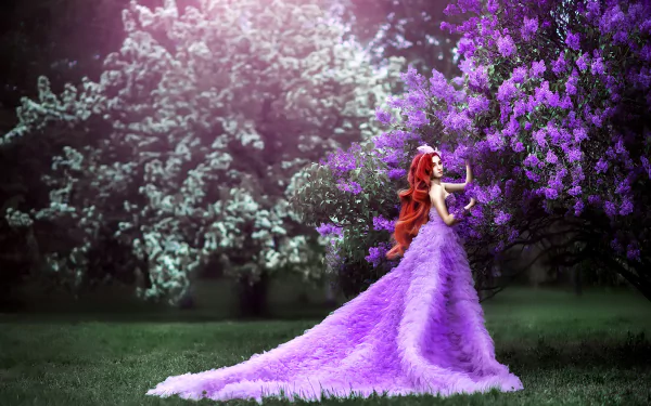 HD PC desktop wallpaper of a redhead model with long hair in a flowing purple dress among vivid purple blossoms, shallow depth of field, romantic garden background.