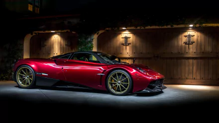 A striking red Pagani Huayra supercar parked in front of a wooden gate, showcased in 4K Ultra HD as a PC desktop wallpaper and background.