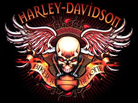 HD desktop wallpaper featuring a vibrant Harley-Davidson logo with a skull, wings, and the slogan Biker to the Bone integrated into the design.