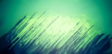Abstract green background featuring dynamic, streaked lines. This HD wallpaper adds a unique and vibrant touch to any desktop setting.
