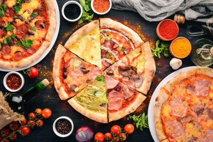 HD desktop wallpaper of a still life featuring an assortment of freshly baked pizzas surrounded by ingredients like tomatoes, herbs, and spices.
