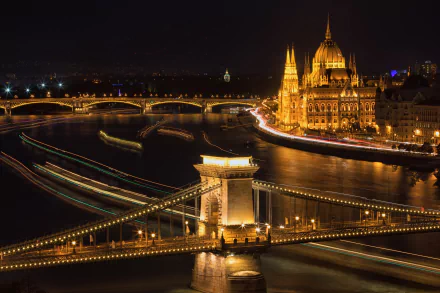 Night view of Budapest featuring the illuminated Chain Bridge, Margaret Bridge, and the Parliament building along the river, captured in a vibrant HD desktop wallpaper.