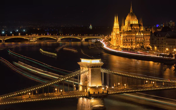Night view of Budapest featuring the illuminated Chain Bridge, Margaret Bridge, and the Parliament building along the river, captured in a vibrant HD desktop wallpaper.