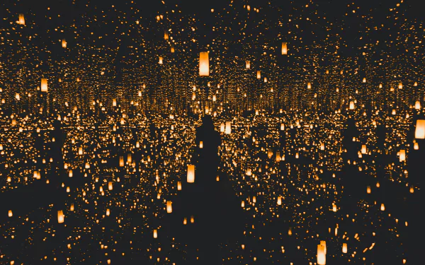 A 4K Ultra HD desktop wallpaper featuring countless man-made lanterns glowing brightly against a dark background, creating a mesmerizing and immersive scene.