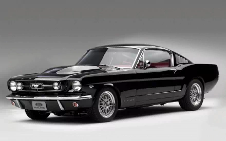 HD desktop wallpaper featuring a sleek black Ford Mustang Fastback, highlighting its classic muscle car design and powerful stance.