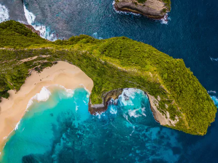 Aerial view of Indonesia's coastline featuring a green arch over a turquoise ocean and sandy beach, captured in stunning 4K Ultra HD quality.