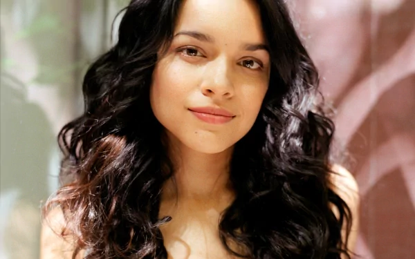 HD desktop wallpaper featuring a close-up portrait of Norah Jones, highlighting her natural beauty with soft lighting and a blurred background.