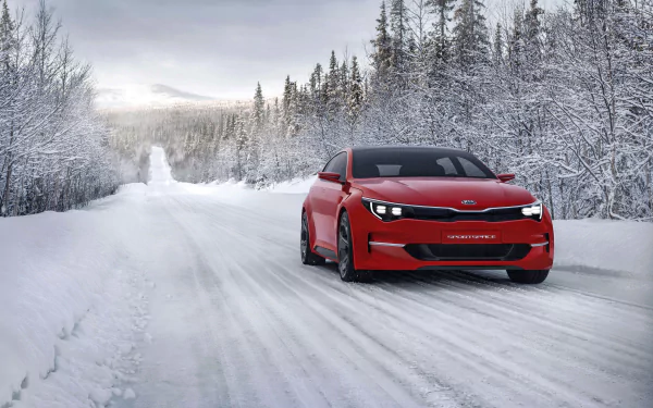 A red Kia Sportspace concept car drives through a snowy forest road, captured in 4K Ultra HD for a PC desktop wallpaper background.