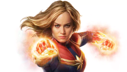 HD desktop wallpaper featuring Brie Larson as Captain Marvel, with blonde hair and glowing fists, in a dynamic action pose from the movie Captain Marvel.