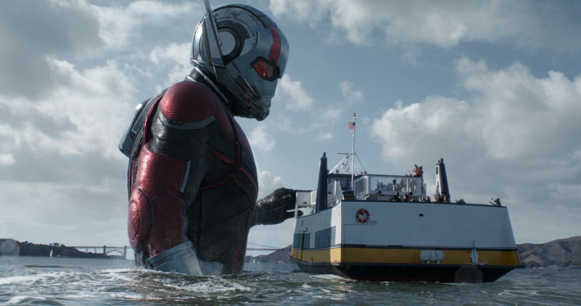 HD PC desktop wallpaper featuring Ant-Man in suit standing waist-deep in water near a ferry, from the movie Ant-Man and the Wasp.