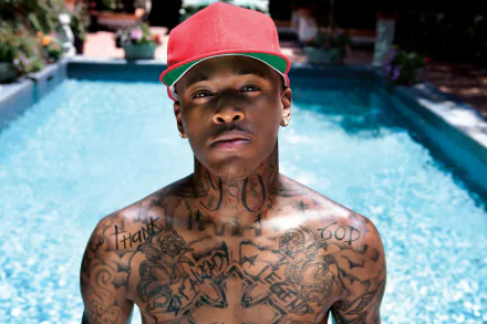HD desktop wallpaper of a person with tattoos standing in front of a pool, tagged with YG.