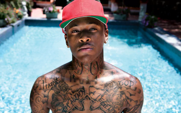 HD desktop wallpaper of a person with tattoos standing in front of a pool, tagged with YG.